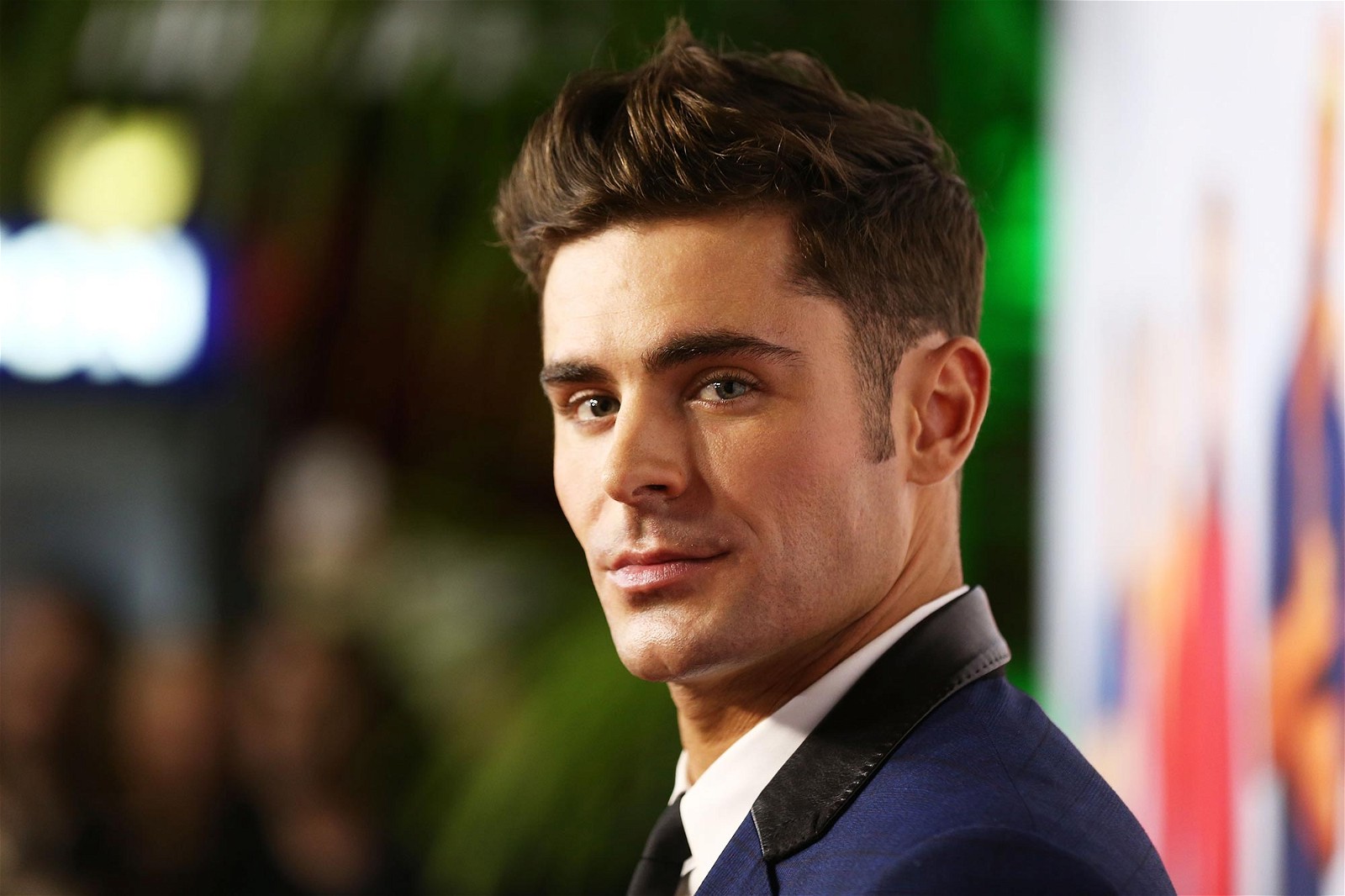 Zac Efron posing for the cameras at an event.