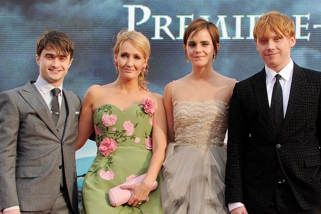 J.K. Rowling along with the cast of Harry Potter.