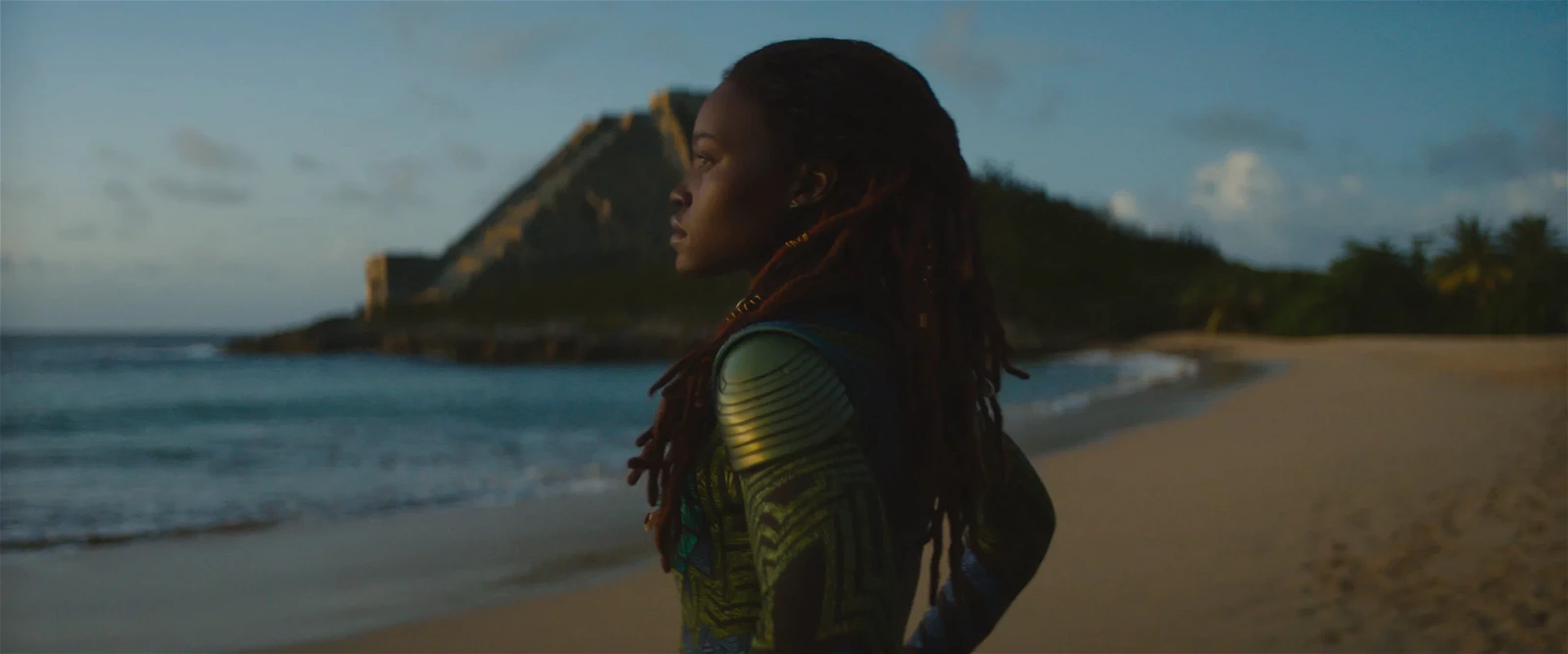 Lupita Nyong'o as Nakia on the beach at the end of Black Panther: Wakanda Forever (2022).