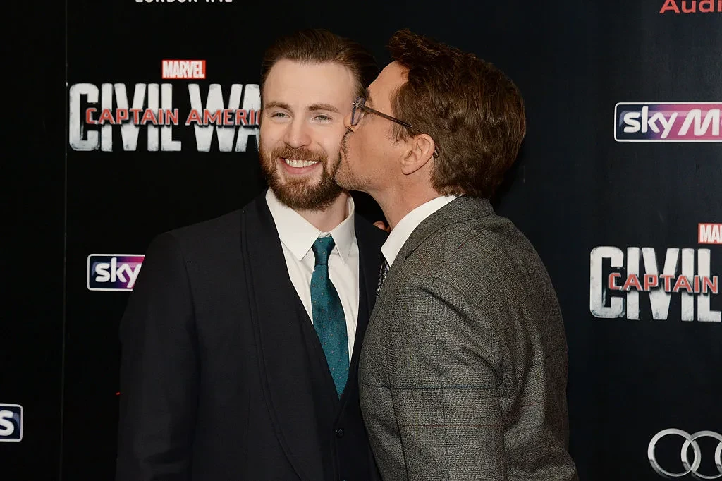 Robert Downey Jr. kissing Chris Evans