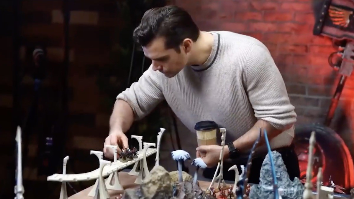 Henry Cavill playing with some Warhammer 40,000 figurines