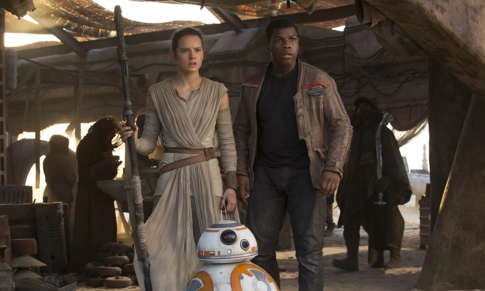 Daisey Ridley as Rey, BB-8, and John Boyega as Finn in Star Wars: The Force Awakens