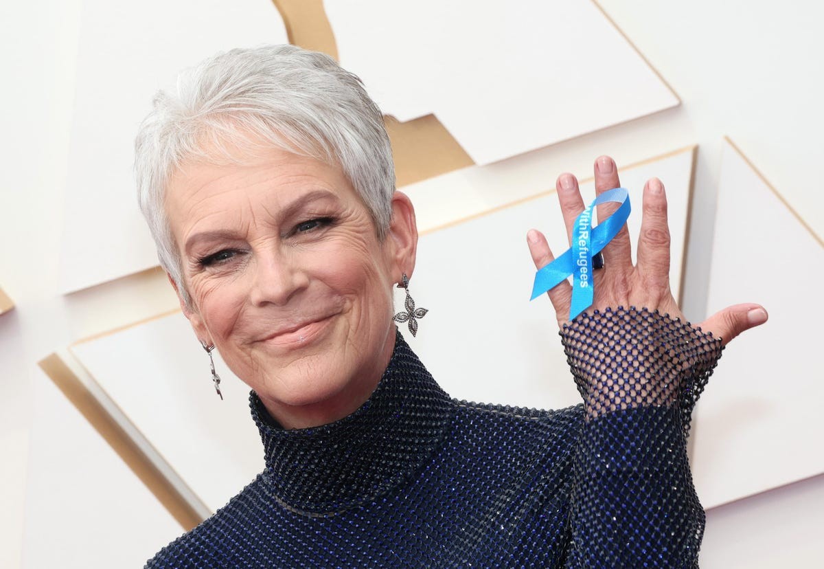 Jamie Lee Curtis shows off her blue ribbon pin at the BAFTA red carpet