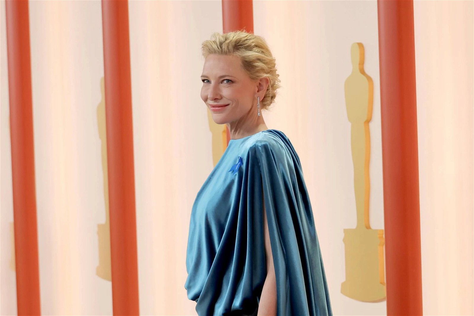 Cate Blanchett in a blue dress and blue ribbon pin at Oscars 2023