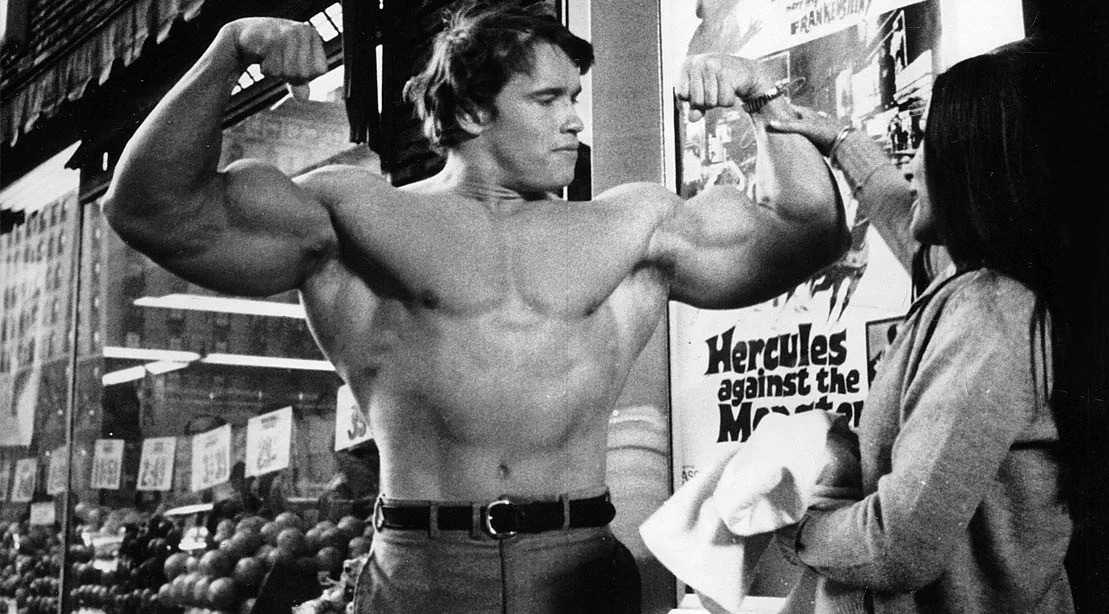 Arnold Schwarzenegger flexing his arms