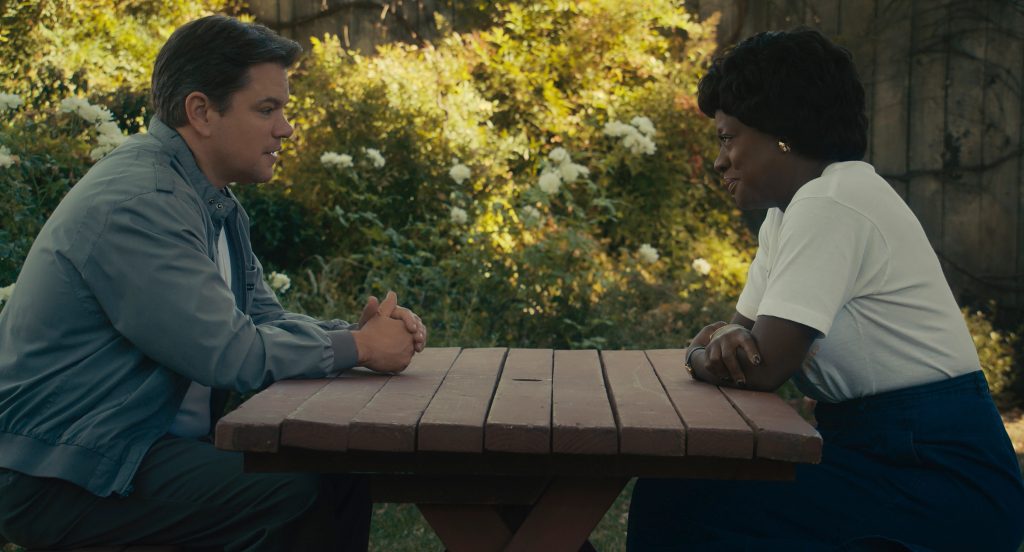 Matt Damon and Viola Davis sitting on a bench in a park in Air