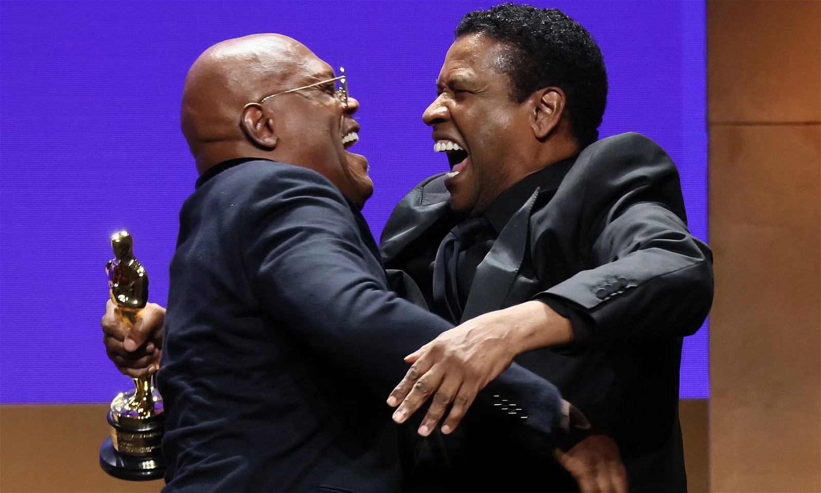 Samuel L. Jackson and Denzel Washington hug after receiving honorary Oscars
