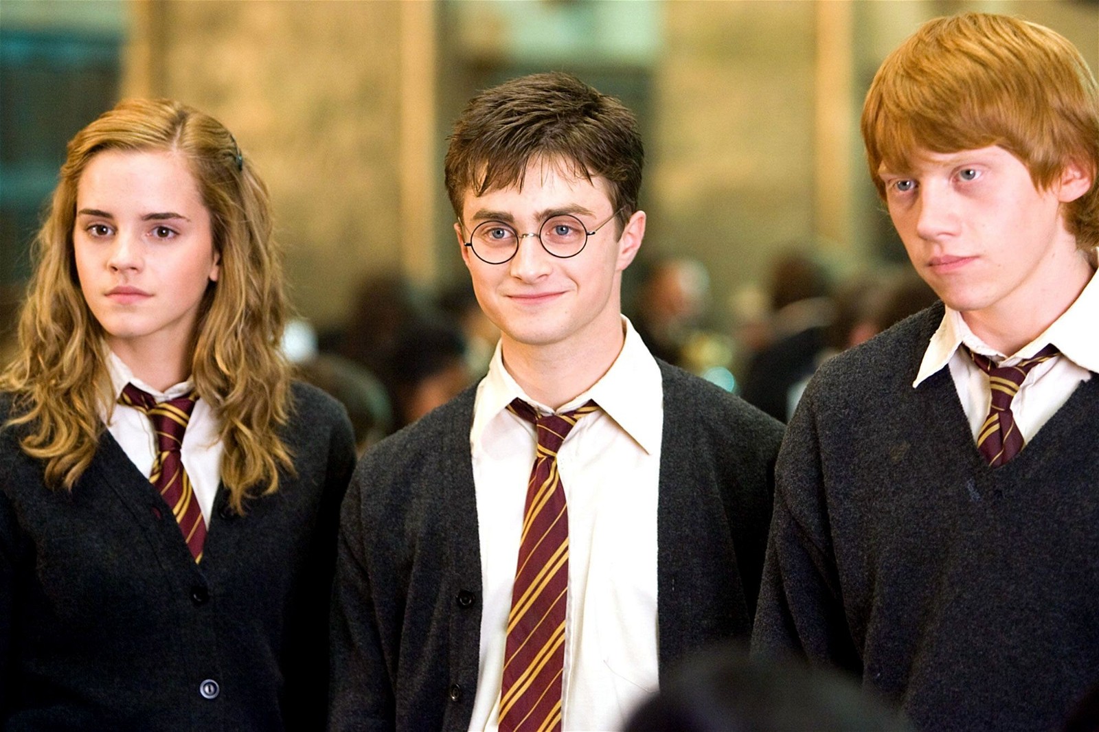 Emma Watson, Daniel Radcliffe, and Rupert Grint in the Harry Potter franchise.