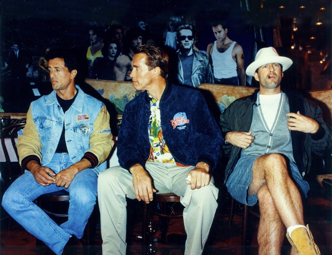 Sylvester Stallone, Arnold Schwarzenegger, and Bruce Willis at a Planet Hollywood event