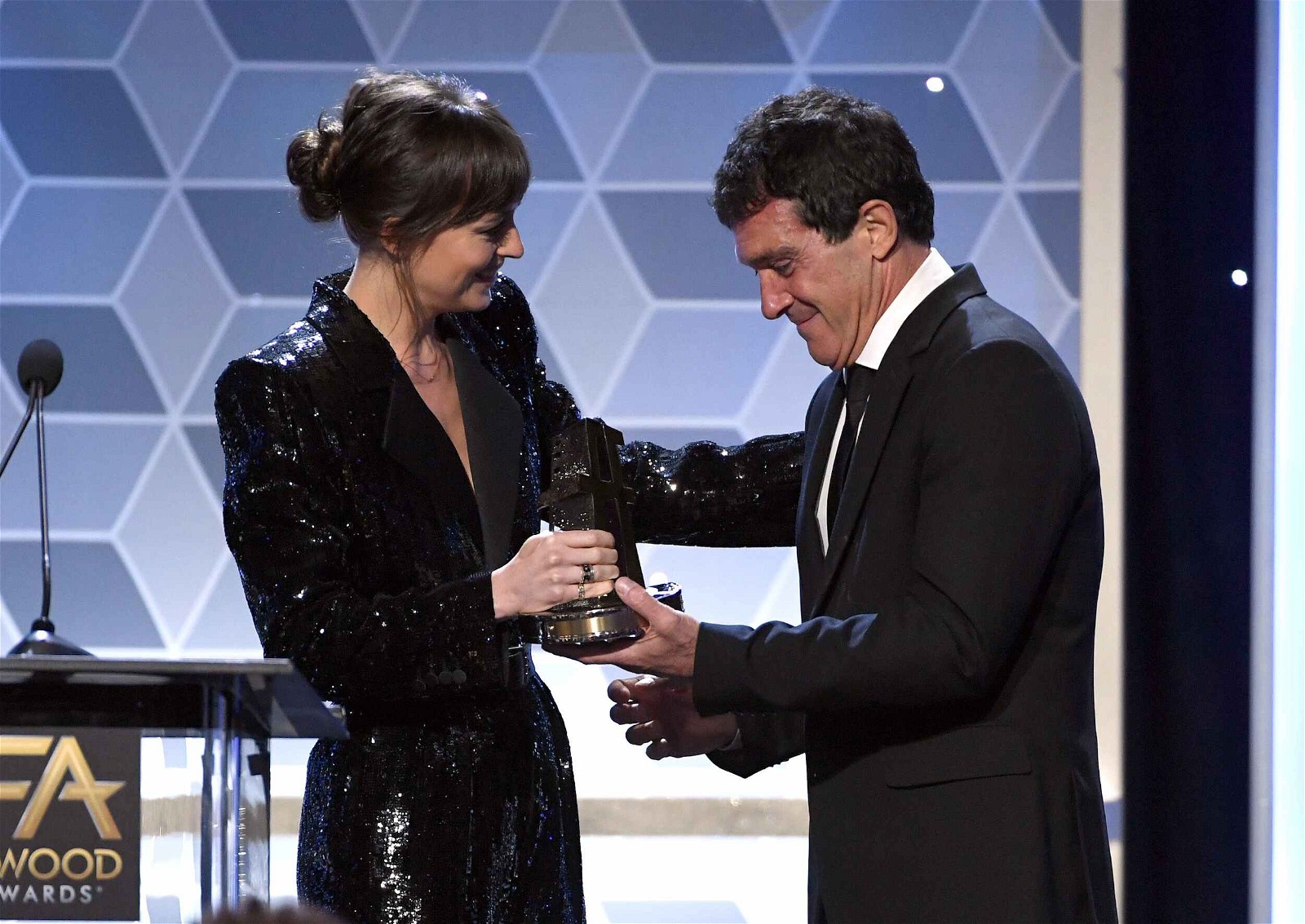 Dakota Johnson presenting the Hollywood Actor Award to Antonio Banderas