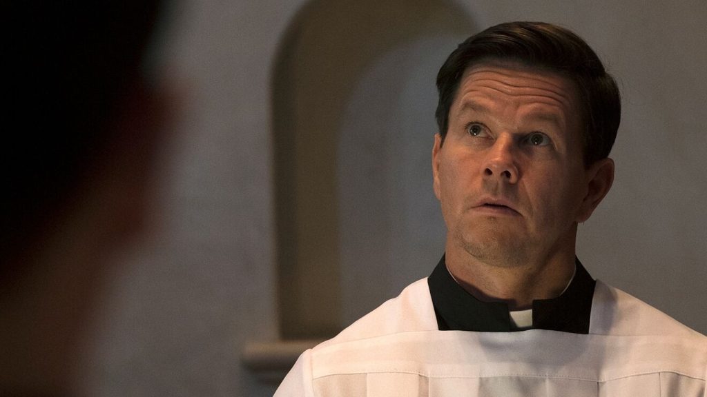 Mark Wahlberg, looking up as a priest in Father Stu