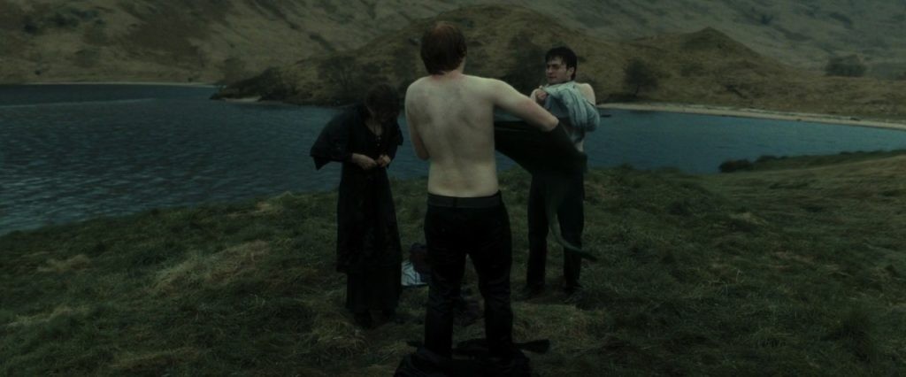 A still of Emma Watson, Rupert Grint, and, Daniel Radcliffe after jumping into the lake.