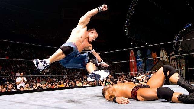 John Cena lands a Five Knuckle Shuffle on Randy Orton.