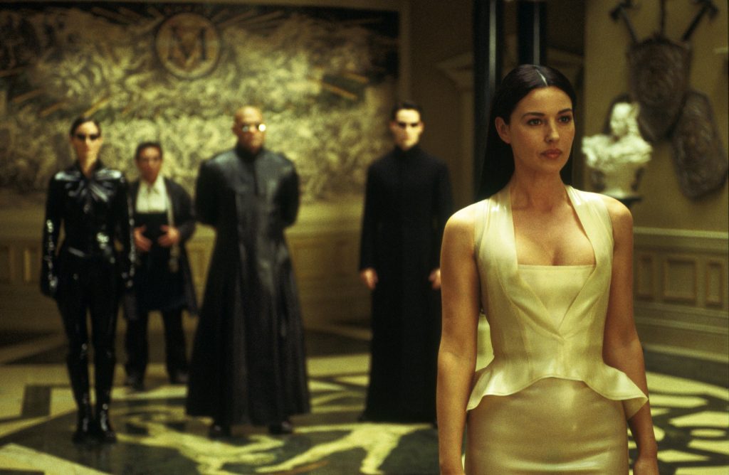 The cast looking at Monica Belluci in The Matrix Reloaded