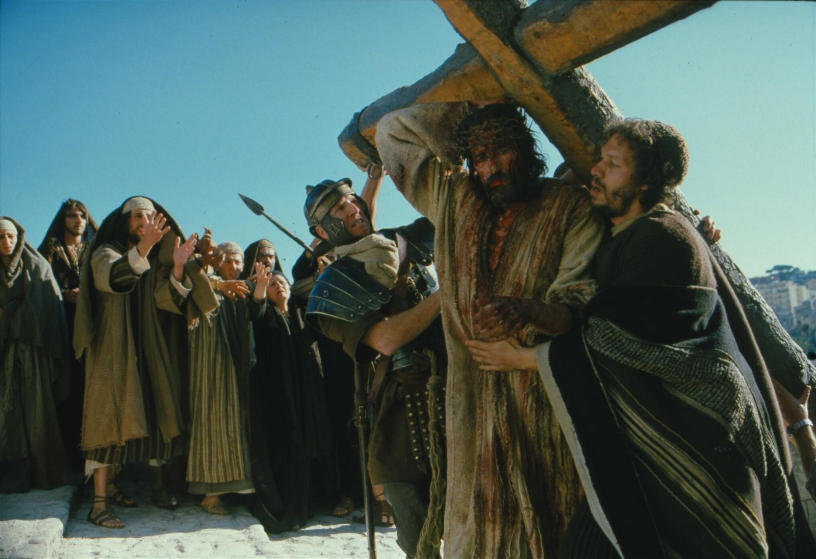 Jim Caviezel lifting the cross in The Passion of the Christ