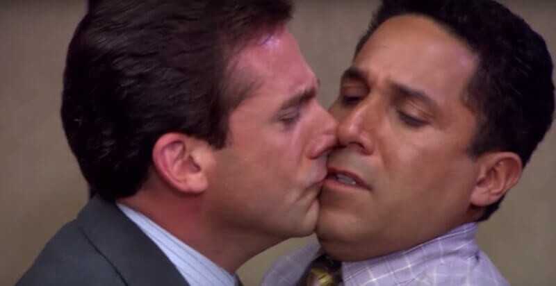 The iconic kiss between Michael Scott and Oscar Martinez