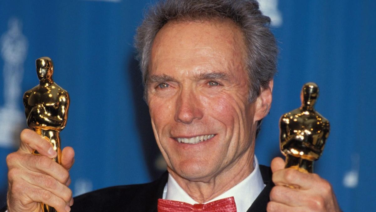 Clint Eastwood with his Oscars posing for photos