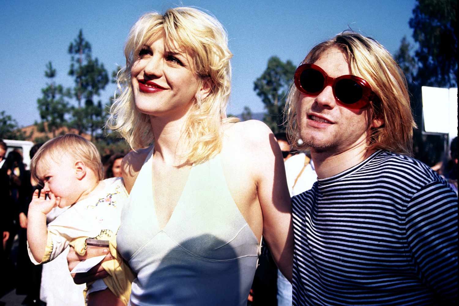 Courtney Love and Kurt Cobain with their child