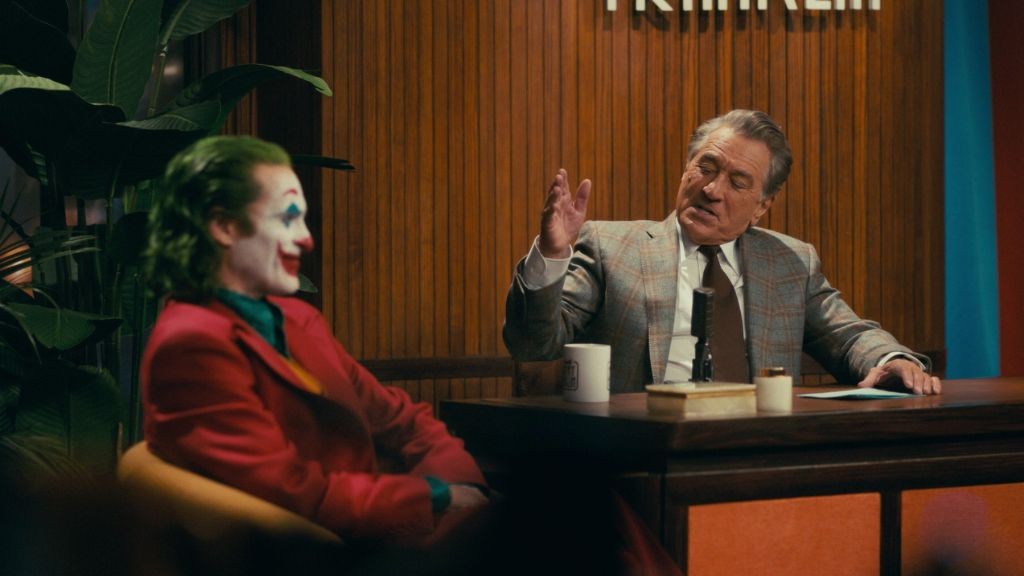 Joaquin Phoenix in his titular character alongside Robert De Niro's Murray Franklin in Joker (2019)