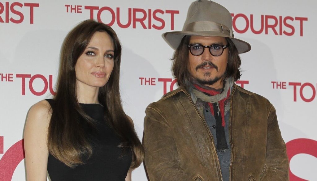 Angelina Jolie with Johnny Depp while promoting their movie together, The Tourist