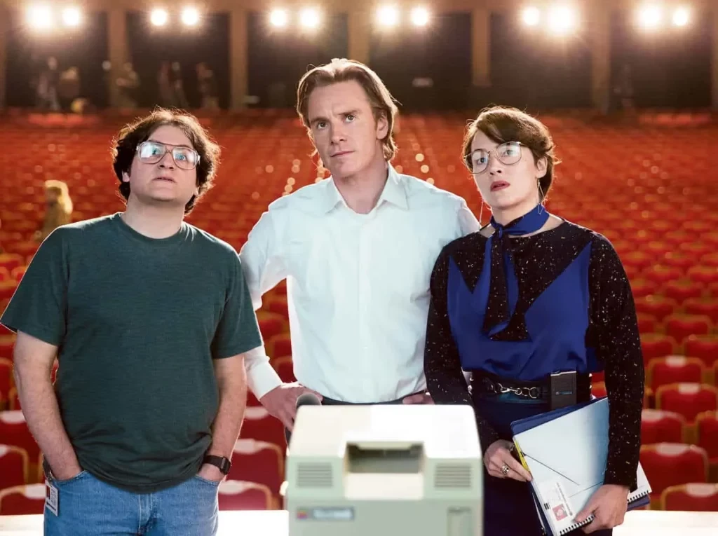 Winslet (R) and Fassbender (C) in a still from Steve Jobs