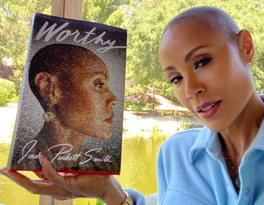 Jada Pinkett Smith holding her book Worthy