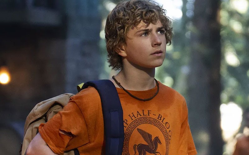 Walker Scobell as Percy Jackson while in a forest and looking ahead