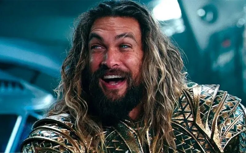 Jason Momoa as Aquaman smiling in this scene wearing his armour