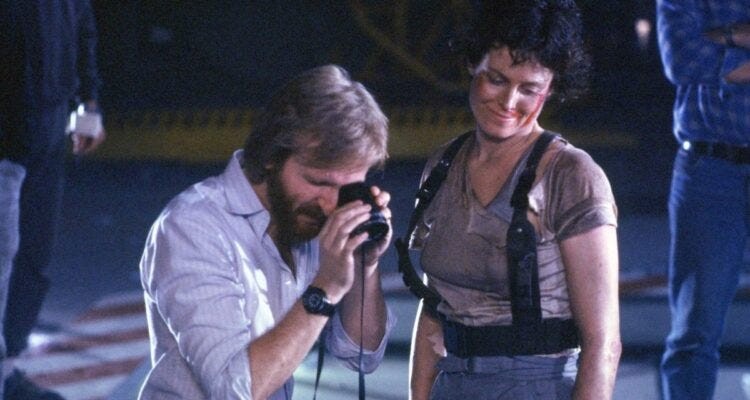James Cameron is using a camera to zoom in on something on the set of Aliens