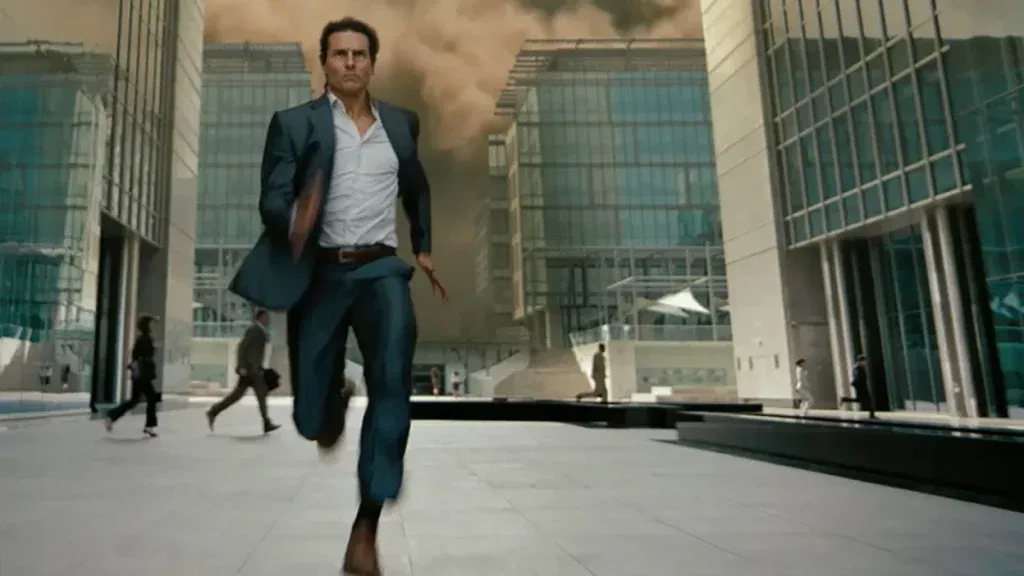 Tom Cruise running while a sandstorm comes behind him in Universal Pictures' The Mummy