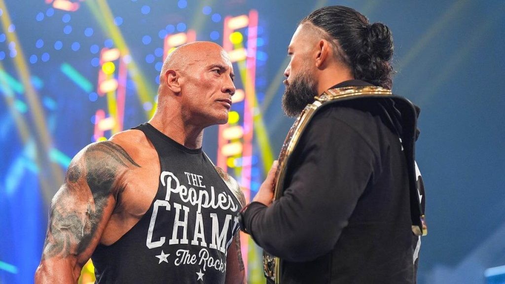 Dwayne Johnson facing off against Roman Reigns at the SmackDown