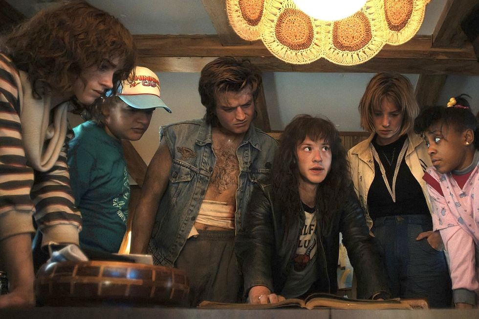 Joe Keery as Steve and Joseph Quinn as Eddie along with other stars in Netflix's Stranger Things