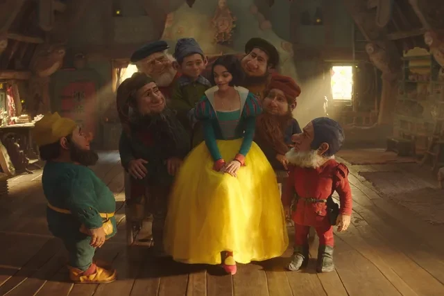 Snow White (Rachel Zegler) and (alphabetically) Bashful, Doc, Dopey, Grumpy, Happy, Sleepy, and Sneezy, in Disney’s Snow White. Image: Disney