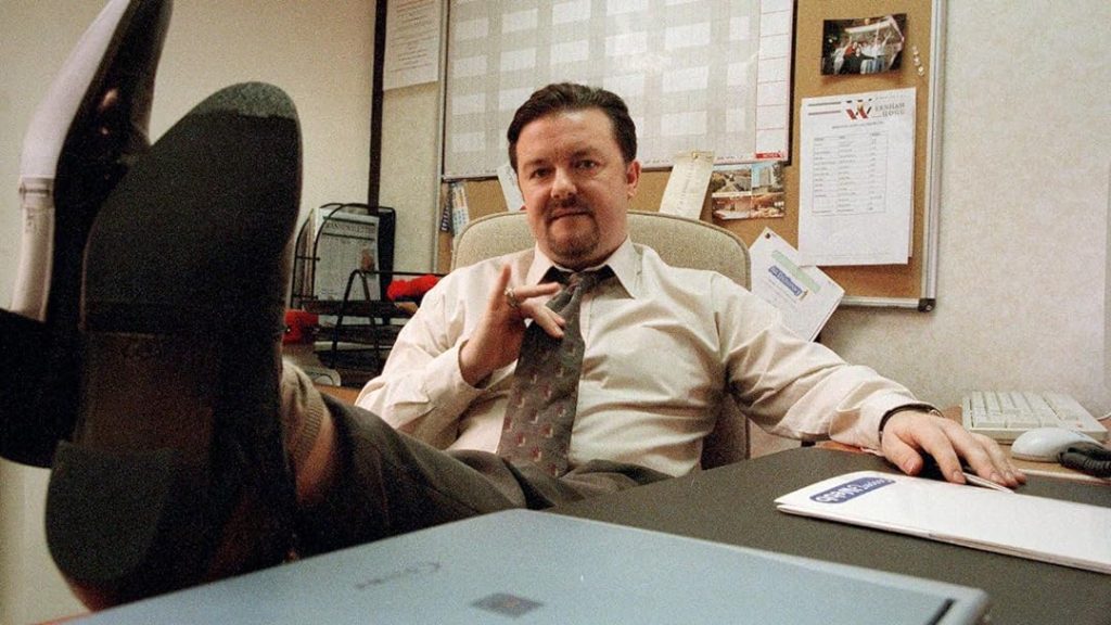 Ricky Gervais as the awkward boss David Brent in the OG mockumentary sitcom The Office. 