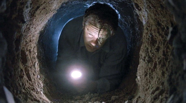 Andy escaping prison through the hole.