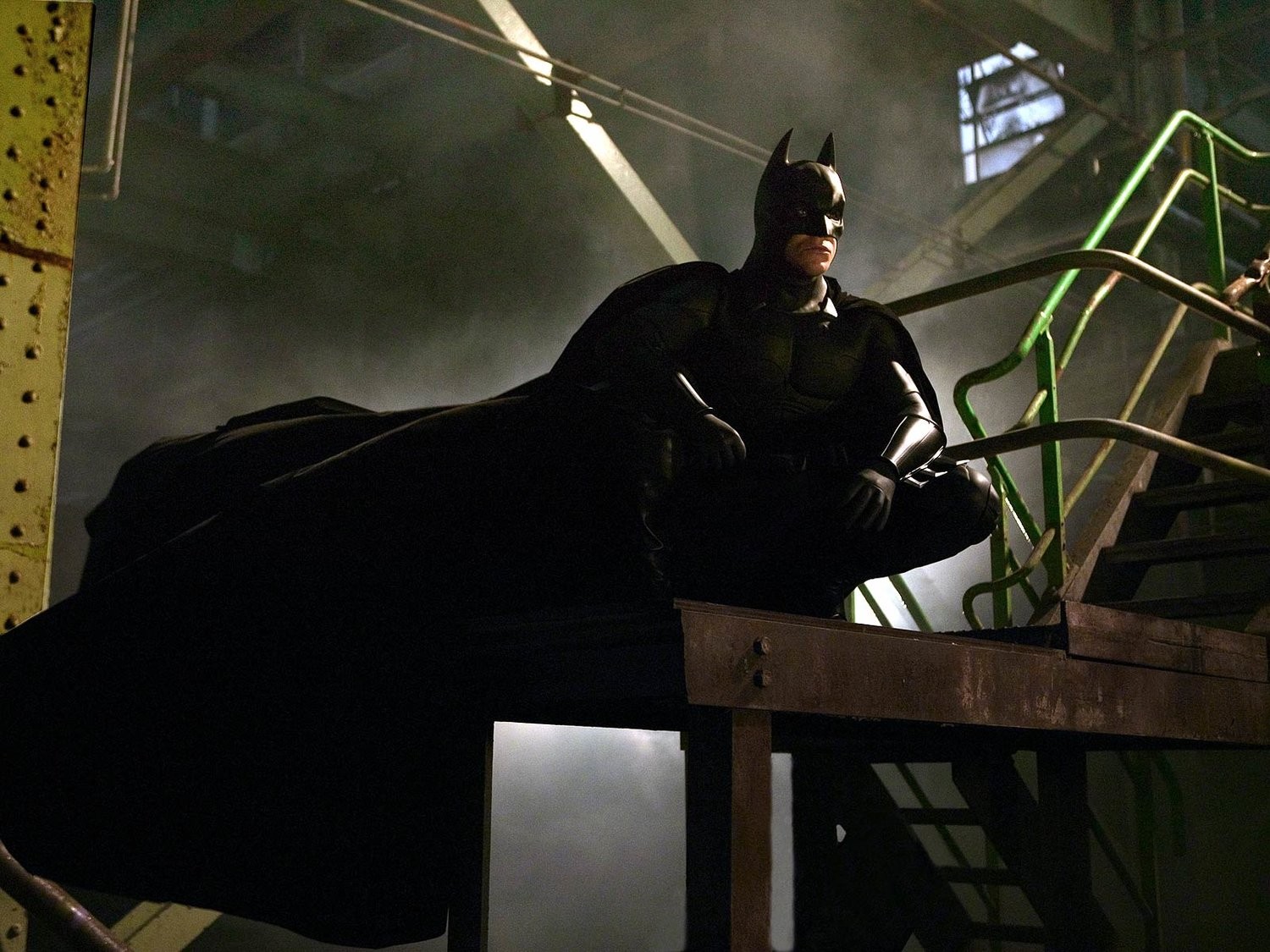 Christian Bale's Batman intimidates a thug in Arkham Asylum in Christopher Nolan's Batman Begins