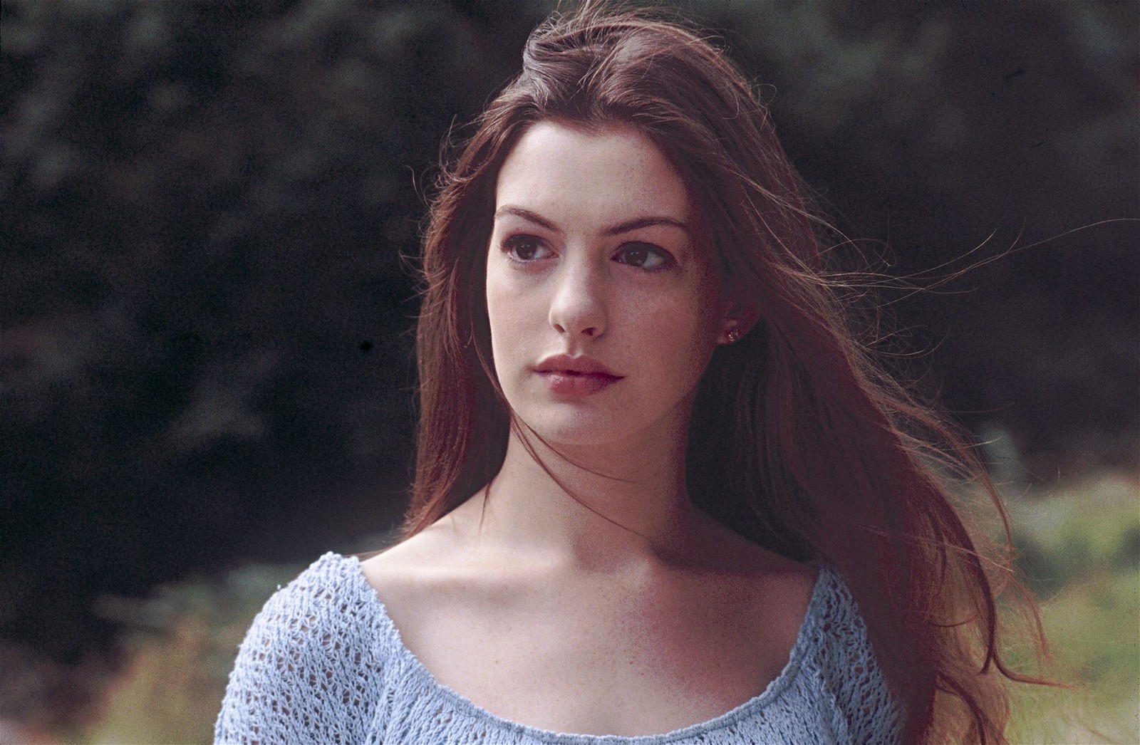 Actress Anne Hathaway stands amidst a field in Ella Enchanted