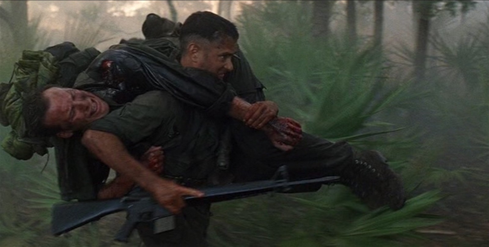 Forrest Gump carrying his fallen comrade to safety during the Vietnam War in Forrest Gump