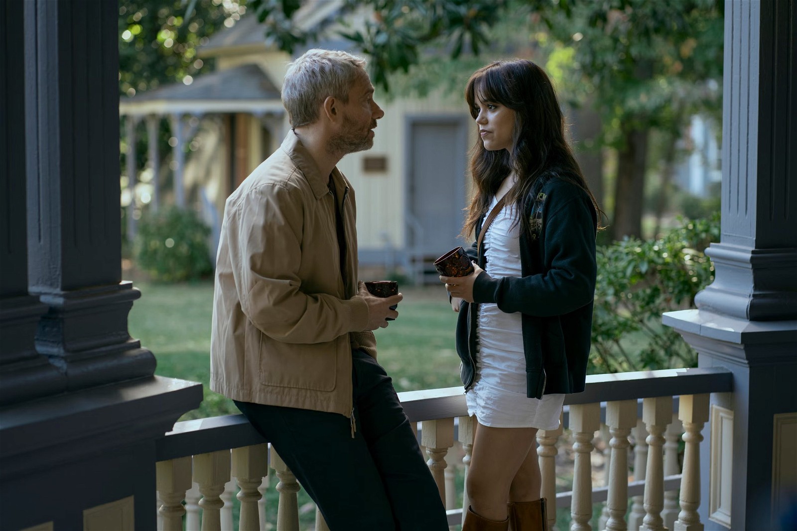 Martin Freeman and Jenna Ortega bond over coffee at the porch of a house in Miller's Girl