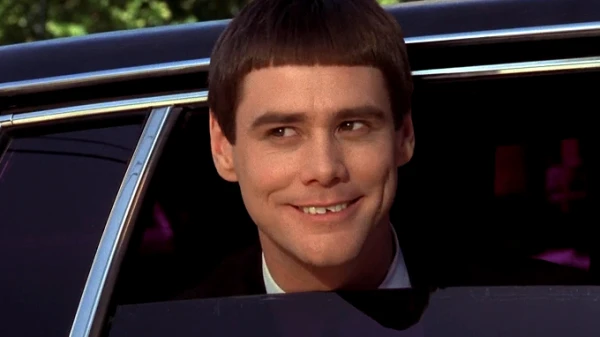 Jim Carrey's iconic bowl haircut and clipped tooth as Lloyd Christmas in Dumb and Dumber