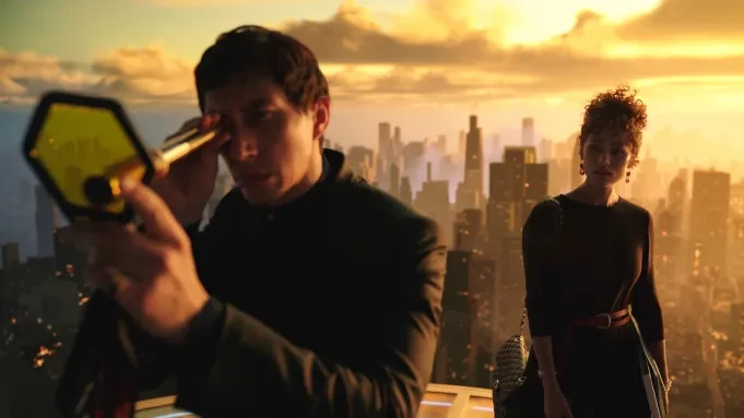 Adam Driver and Nathalie Emmanuel stand atop a skyscraper in New York in a still from Megalopolis