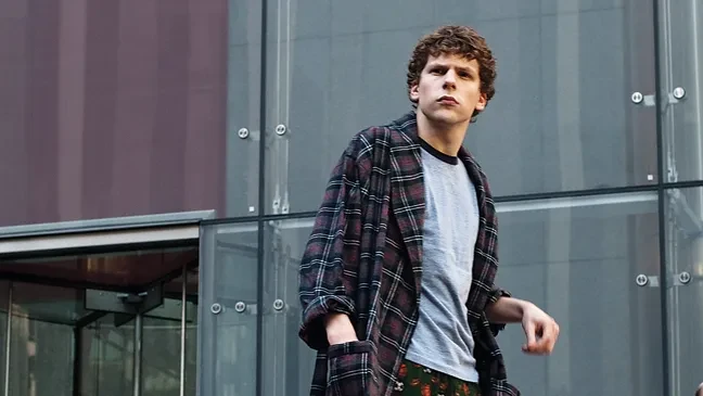Jesse Eisenberg as Mark Zuckerberg walks out of a business meeting in The Social Network