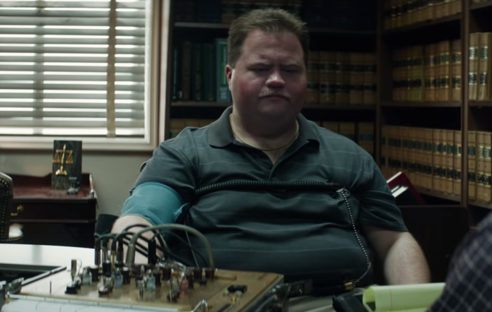 Paul Walter Hauser takes a lie detector test in a still from Richard Jewell
