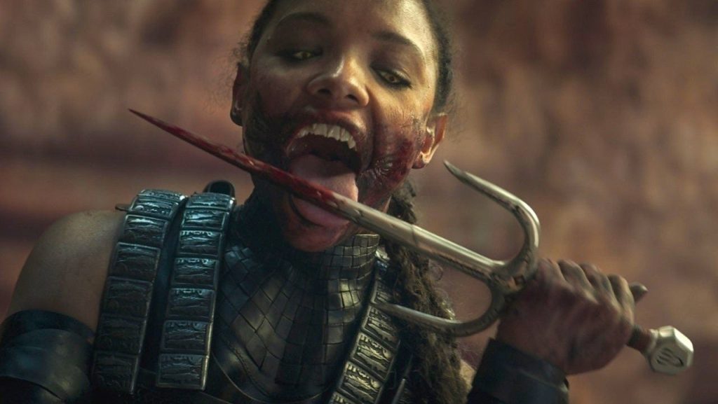 Sisi Stringer as Mileena licking a weapon