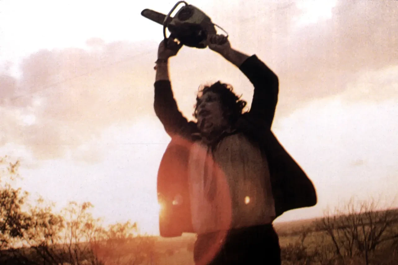 Leatherface celebrates a kill in The Texas Chainsaw Massacre (1974)