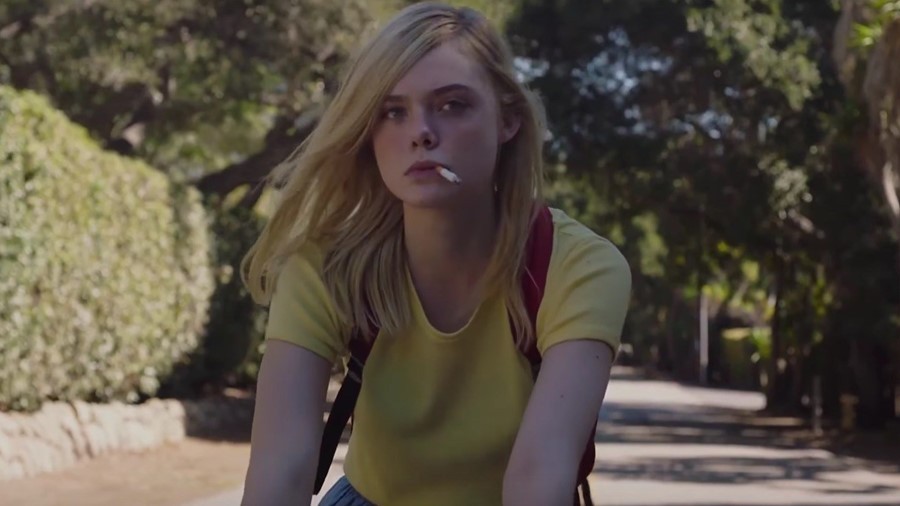 Elle Fanning rides a bicycle in a still from 20th Century Women