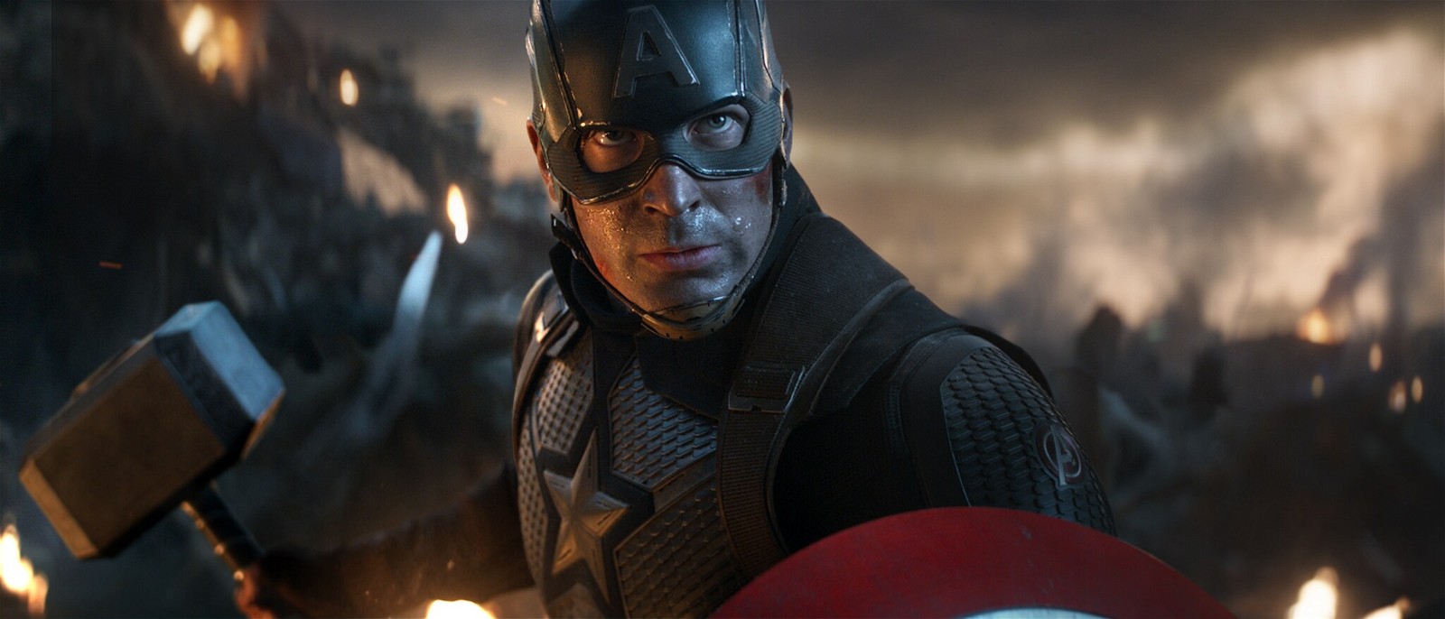 Chris Evans as Captain America lifting the Mjolnir