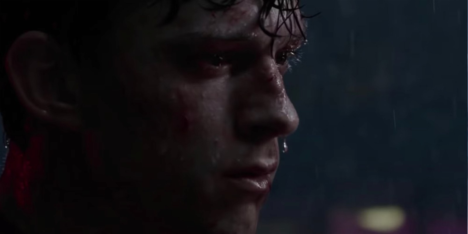 Tom Holland's Spider-Man close-up showcasing him grieving Aunt May in Spider-Man: No Way Home