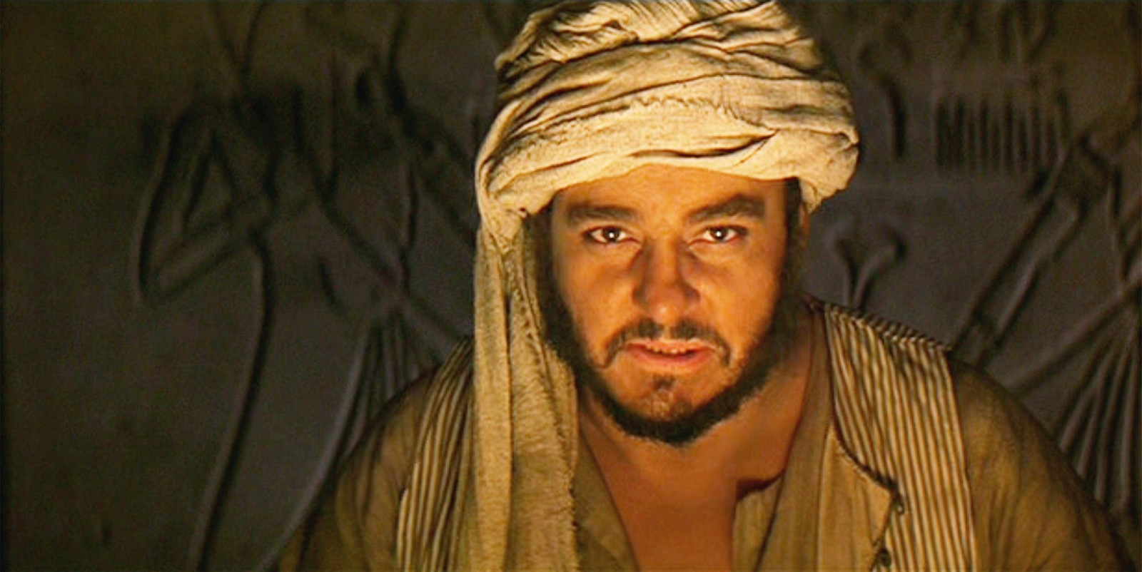 John Rhys-Davies smiling as Sallah in Indiana Jones