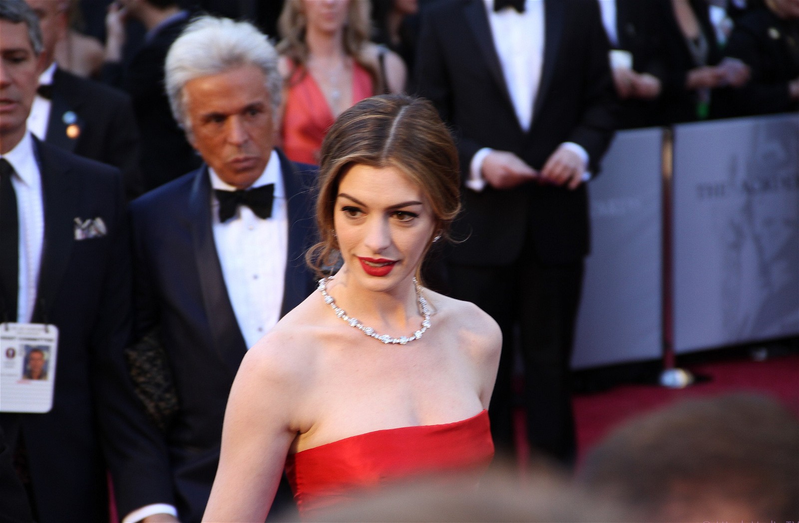 Anne Hathaway smiling on 83rd Academy Awards red carpet